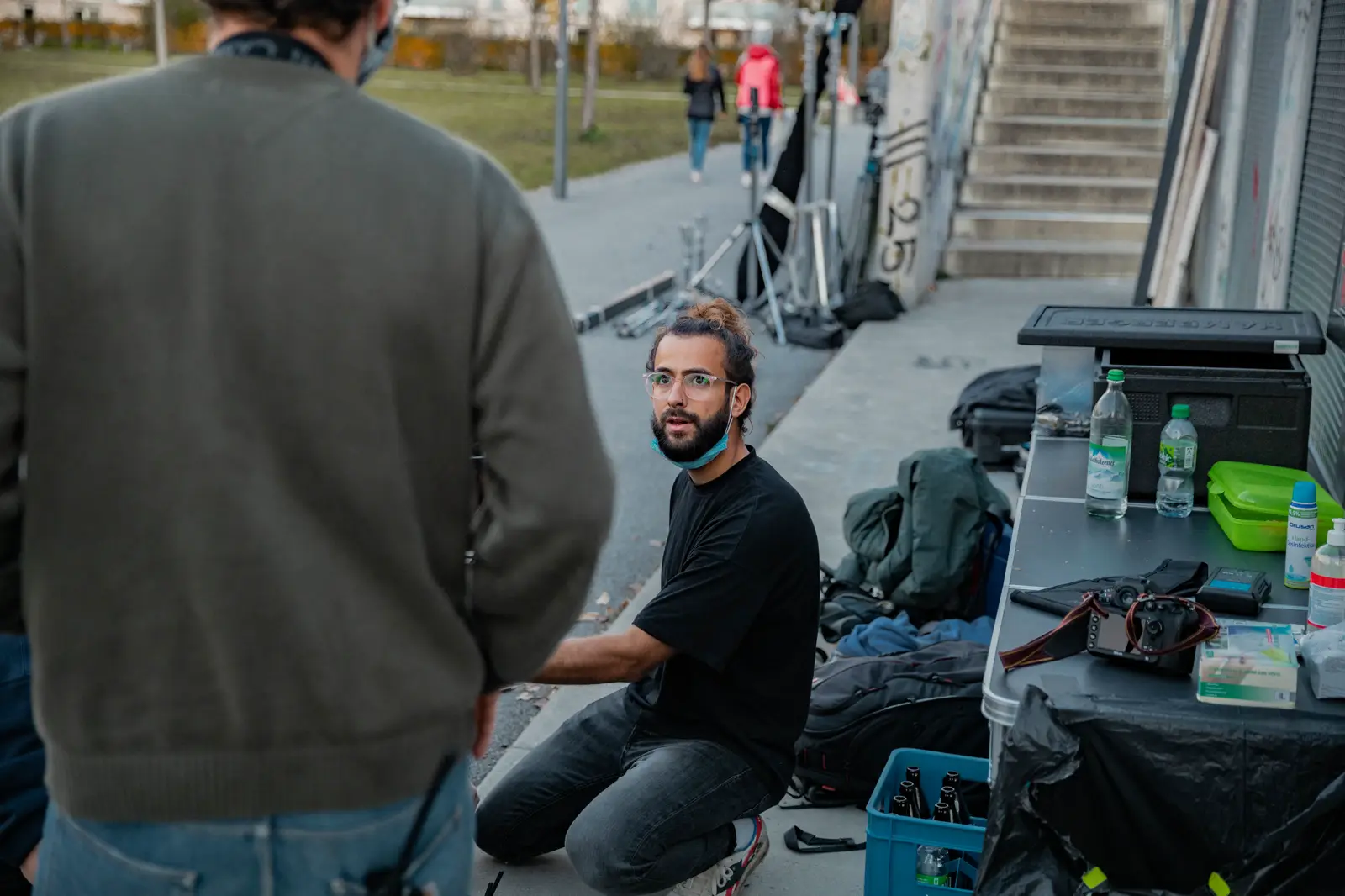 Andreas on set, crouching next to the camera cart